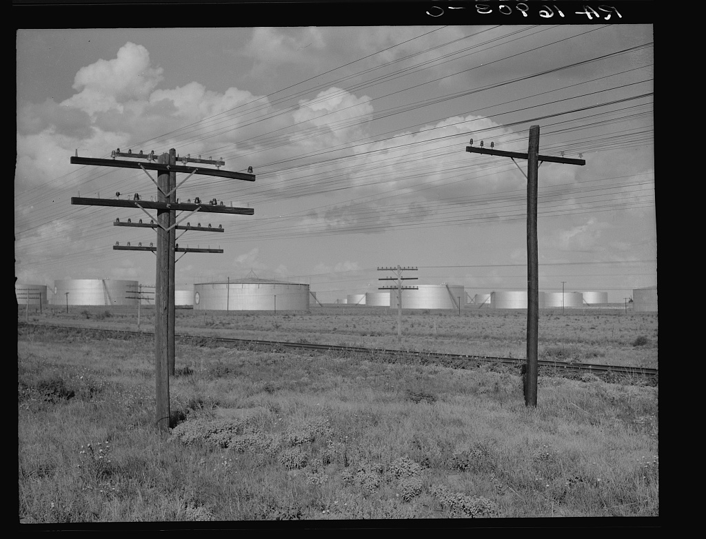 Oil storage tanks and utility lines near Midland, Texas, in 1937
